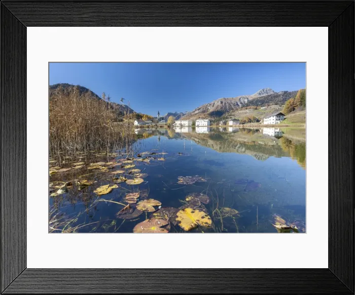 Framed Print : The little village of Tarasp in Low Engadine reflecting in a nearby pond, half covered in water lily leaves, Graubunden, Switzerland, Europe Framed Print : The little village of Tarasp in Low Engadine reflecting in a nearby pond, half covered in water lily leaves, Graubunden, Switzerland, Europe