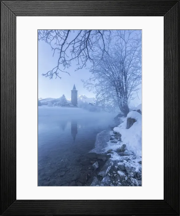 Framed Print : The church of Sils-Baselgia, in a winter landscape covered in snow in Engadine, from the misty banks of River Inn at sunrise, Graubunden, Switzerland, Europe Framed Print : The church of Sils-Baselgia, in a winter landscape covered in snow in Engadine, from the misty banks of River Inn at sunrise, Graubunden, Switzerland, Europe