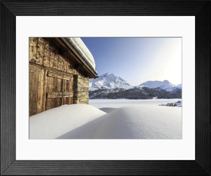 Framed Print : The sun, covered by thin clouds, illuminating a typical hut covered with snow at the Maloja Pass, Graubunden, Swiss Alps, Switzerland, Europe Framed Print : The sun, covered by thin clouds, illuminating a typical hut covered with snow at the Maloja Pass, Graubunden, Swiss Alps, Switzerland, Europe