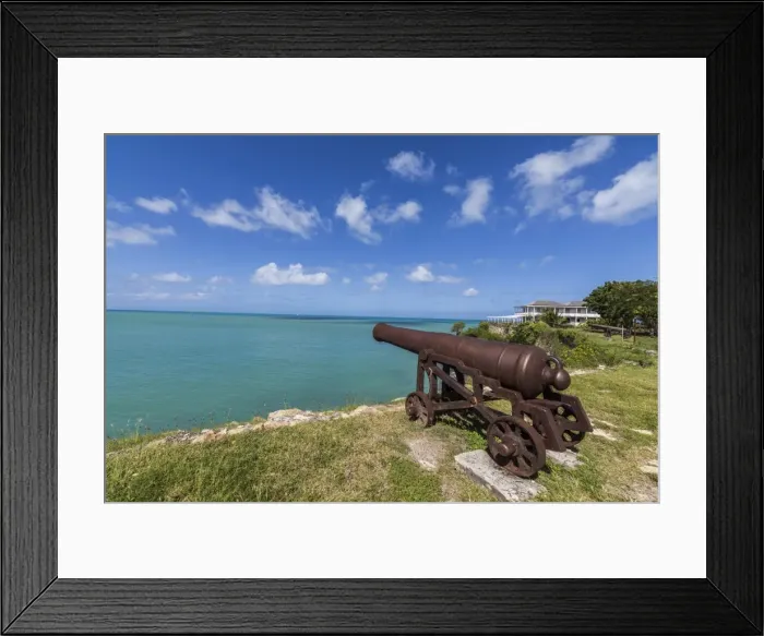 Framed Print : A cannon dating from the 17th century stands guard at Fort James one of the most Framed Print : A cannon dating from the 17th century stands guard at Fort James one of the most