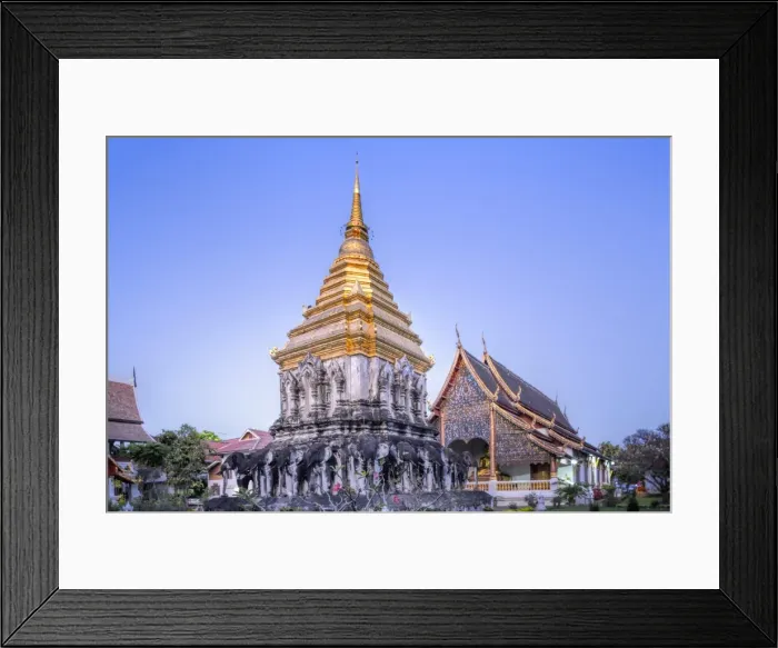 Framed Print : Elephant sculptures on the Chedi Chang Lom and the main bot at the temple of Wat Chiang Man Framed Print : Elephant sculptures on the Chedi Chang Lom and the main bot at the temple of Wat Chiang Man