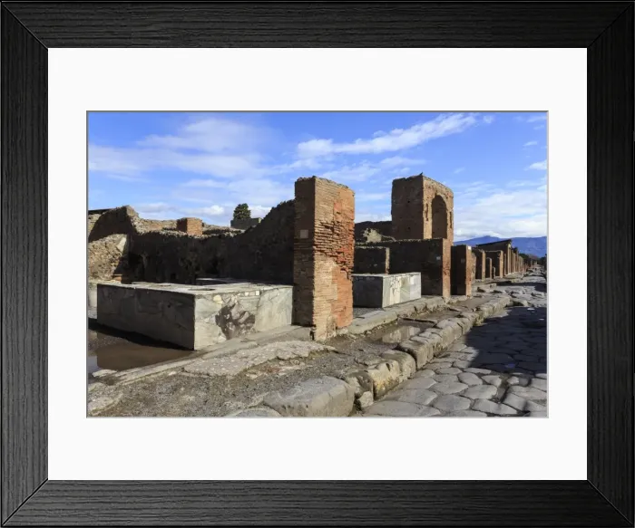 Framed Print : Cobbled street with thermopolium counters and arch, Roman ruins of Pompeii, UNESCO Framed Print : Cobbled street with thermopolium counters and arch, Roman ruins of Pompeii, UNESCO