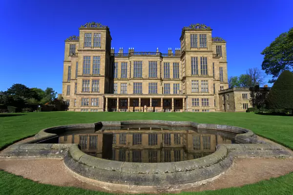 Hardwick Hall, near Chesterfield, reflected in pond under a clear blue sky, Derbyshire
