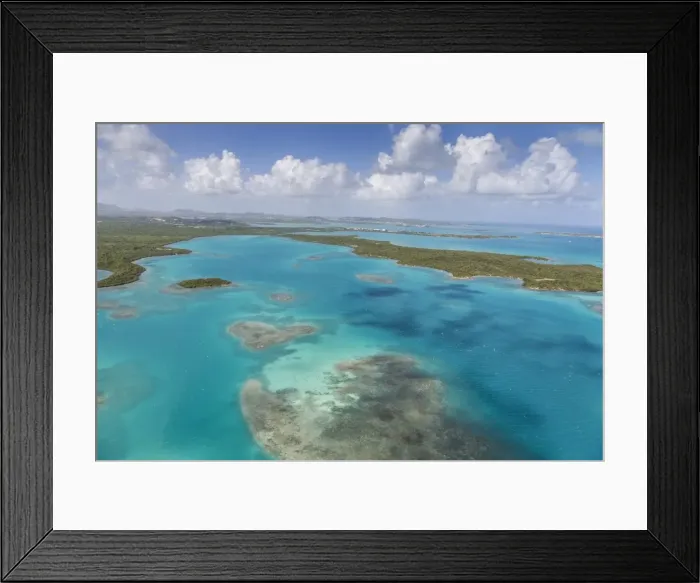 Framed Print : Aerial view of sections of reef scattered along the rugged coastline and rich tropical Framed Print : Aerial view of sections of reef scattered along the rugged coastline and rich tropical