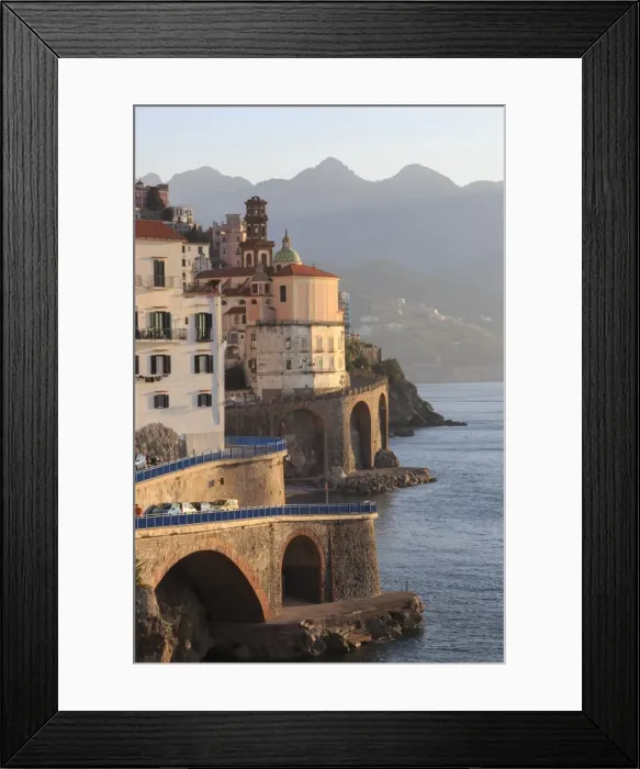 Framed Print : Church of Santa Maria Maddalena and coast road with mountains, warm early morning light Framed Print : Church of Santa Maria Maddalena and coast road with mountains, warm early morning light
