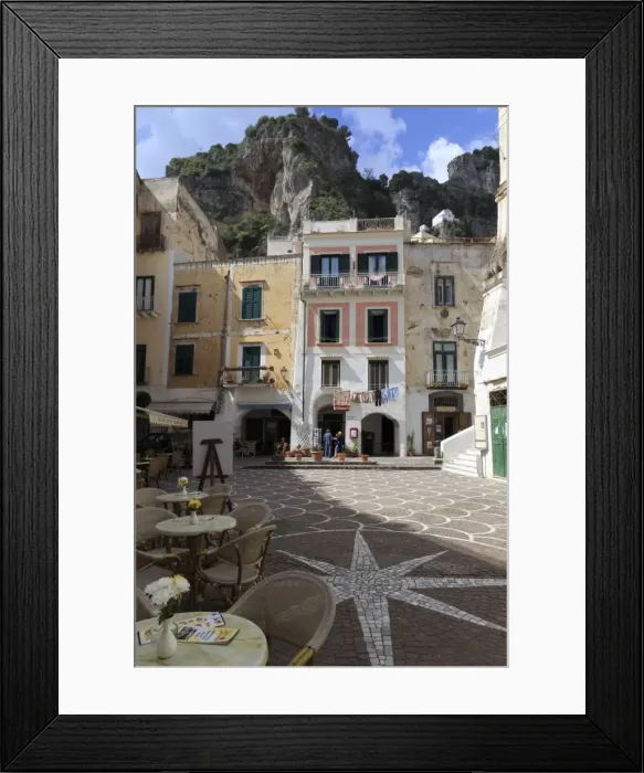 Framed Print : Town square with restaurant tables and colourful buildings, star shaped paving, Atrani Framed Print : Town square with restaurant tables and colourful buildings, star shaped paving, Atrani