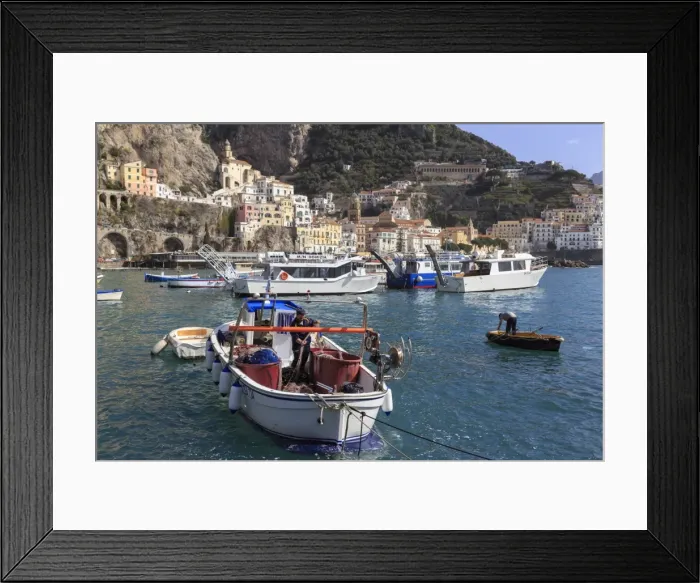 Framed Print : Fisherman in fishing boat in Amalfi harbour, from quayside with view towards Amalfi town Framed Print : Fisherman in fishing boat in Amalfi harbour, from quayside with view towards Amalfi town
