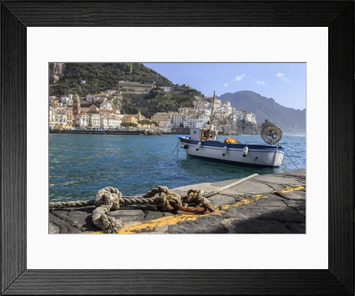 Framed Print : Tethered fishing boat with rope, Amalfi harbour, from quayside with view towards Amalfi town Framed Print : Tethered fishing boat with rope, Amalfi harbour, from quayside with view towards Amalfi town