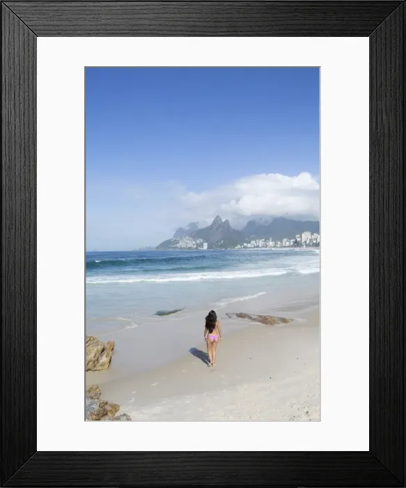 Framed Print : A 20-25 year old young Brazilian woman on Ipanema Beach with the Morro Dois Irmaos Framed Print : A 20-25 year old young Brazilian woman on Ipanema Beach with the Morro Dois Irmaos