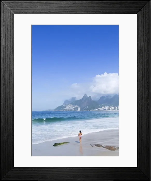 Framed Print : A 20-25 year old young Brazilian woman on Ipanema Beach with the Morro Dois Irmaos Framed Print : A 20-25 year old young Brazilian woman on Ipanema Beach with the Morro Dois Irmaos
