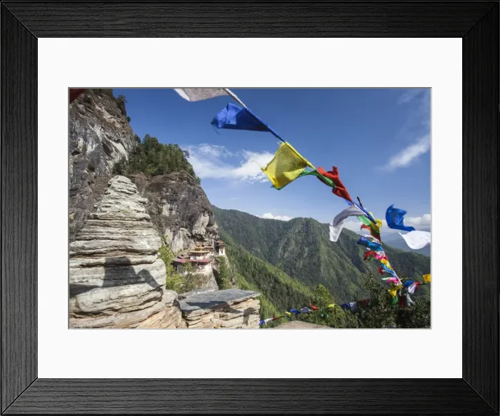 Framed Print : The colorful Tibetan prayer flags invite the faithful to visit the Taktsang Monastery Framed Print : The colorful Tibetan prayer flags invite the faithful to visit the Taktsang Monastery