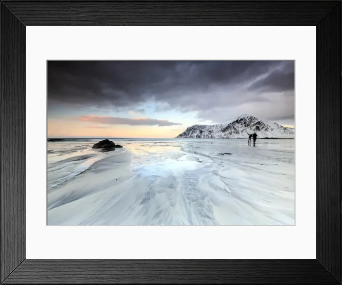 Framed Print : Sunset and hikers on Skagsanden beach surrounded by snow covered mountains, Flakstad Framed Print : Sunset and hikers on Skagsanden beach surrounded by snow covered mountains, Flakstad