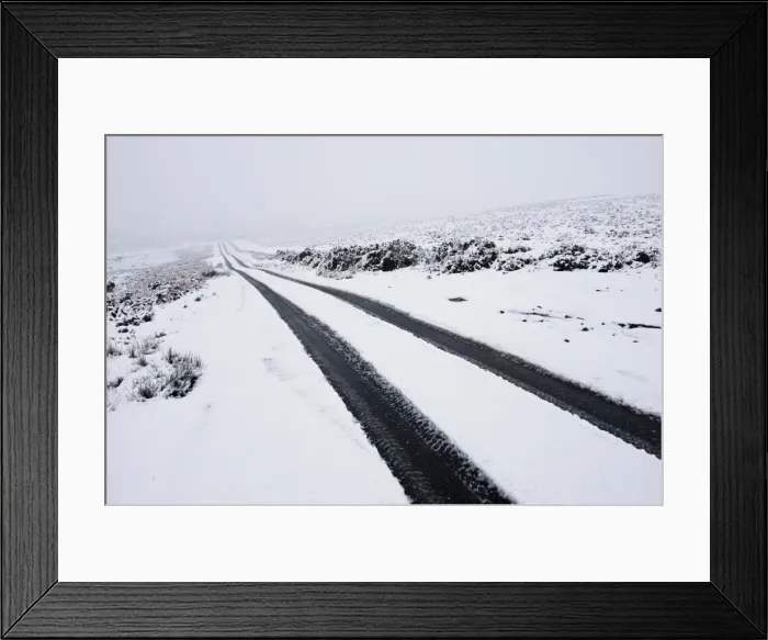Framed Print : Car tyre tracks on a snowy road on the Mynydd Epynt moorland, Powys, Wales, United Kingdom