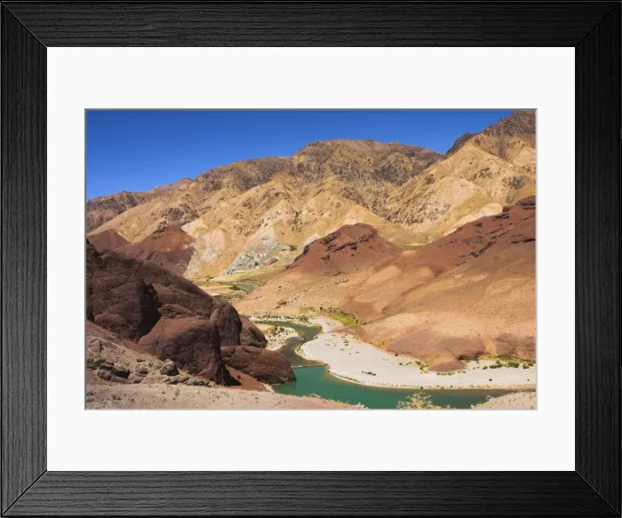 Framed Print : Hari Rud river flows through fertile valley at base of red rock mountains Framed Print : Hari Rud river flows through fertile valley at base of red rock mountains