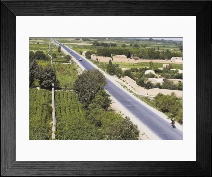 Framed Print : View of man riding horse along road, taken from army checkpoint at remains of a Buddhist stupa Framed Print : View of man riding horse along road, taken from army checkpoint at remains of a Buddhist stupa