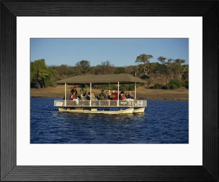 Framed Print : Tourists game viewing on boat on the Chobe River, Chobe National Park, Botswana, Africa Framed Print : Tourists game viewing on boat on the Chobe River, Chobe National Park, Botswana, Africa