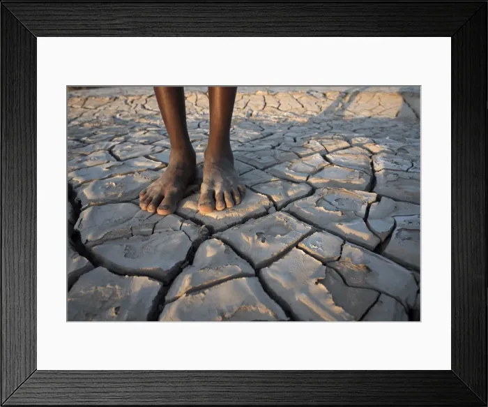 Framed Print : A boy stands in the desolate landscape of Lac Abbe, Djibouti, Africa Framed Print : A boy stands in the desolate landscape of Lac Abbe, Djibouti, Africa