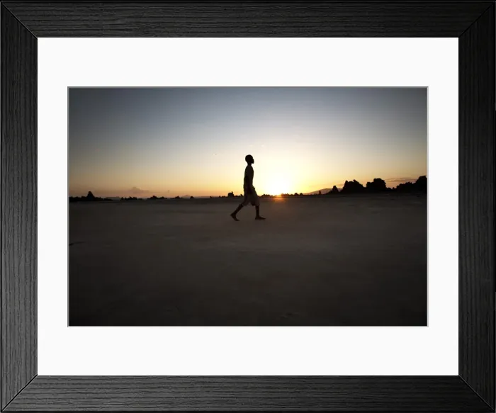 Framed Print : A boy walks through the desolate landscape of Lac Abbe, Djibouti, Africa Framed Print : A boy walks through the desolate landscape of Lac Abbe, Djibouti, Africa