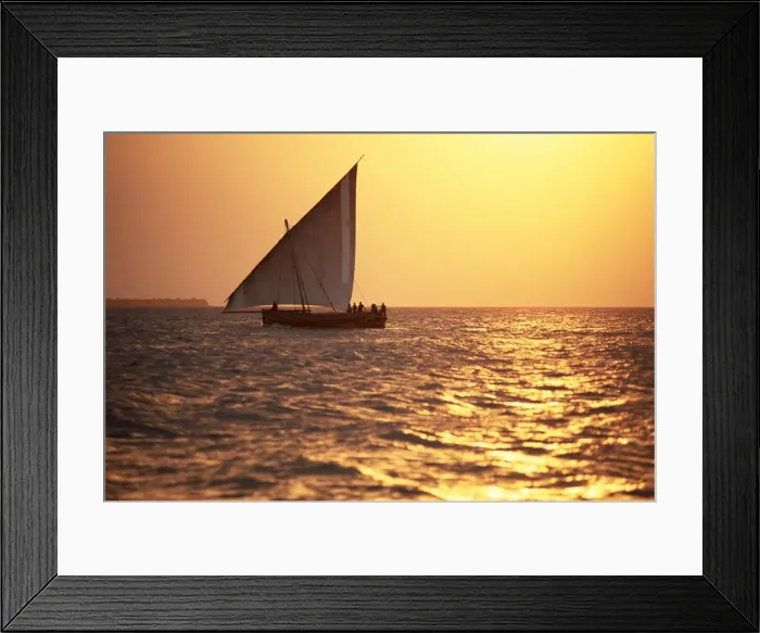 Framed Print : Dhow in silhouette on the Indian Ocean at sunset, off Stone Town, Zanzibar