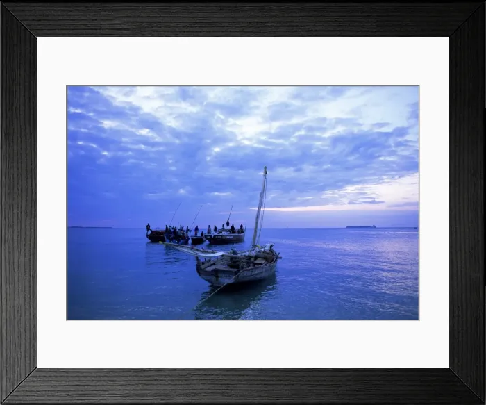 Framed Print : Fishing boats on the Indian Ocean at dusk, off Stone Town, Zanzibar, Tanzania Framed Print : Fishing boats on the Indian Ocean at dusk, off Stone Town, Zanzibar, Tanzania
