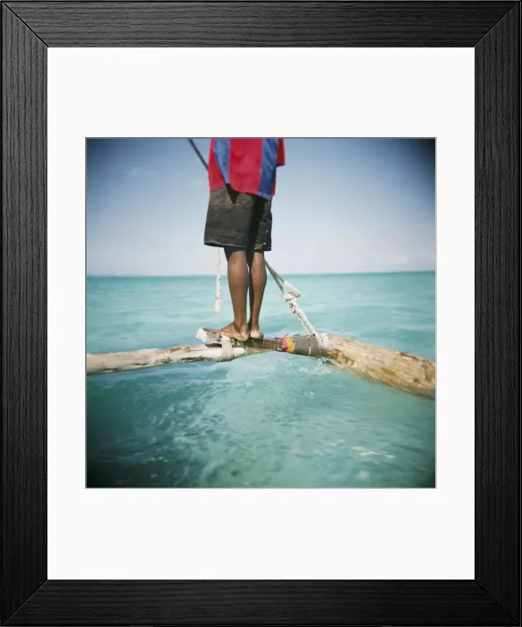 Framed Print : Man standing on outrigger in Indian Ocean, Zanzibar, Tanzania, East Africa, Africa Framed Print : Man standing on outrigger in Indian Ocean, Zanzibar, Tanzania, East Africa, Africa
