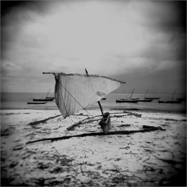 Image taken with a Holga medium format 120 film toy camera of dhow on beach in stormy weather