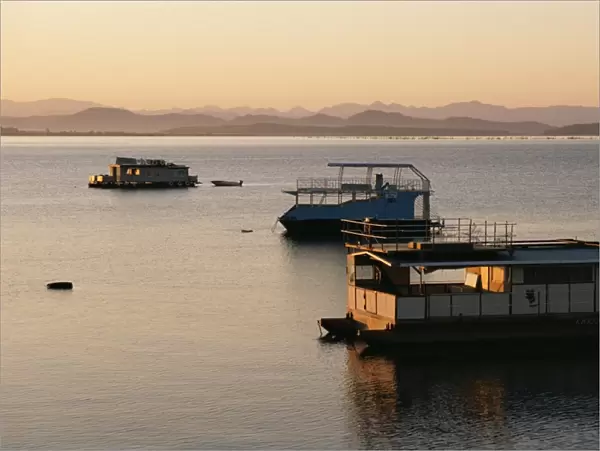 Houseboats at dawn at Cutty Sark Hotel marina, Lake Kariba, Zimbabwe, Africa