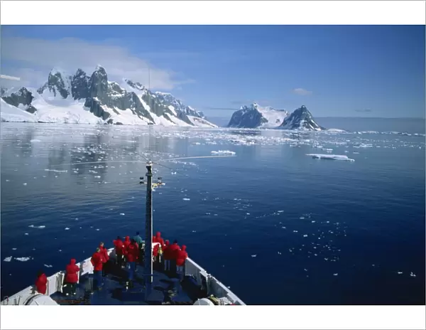 Tourists on the bow of a cruise ship off the Antarctic Peninsula, Antarctica