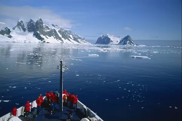 Tourists on the bow of a cruise ship off the Antarctic Peninsula, Antarctica