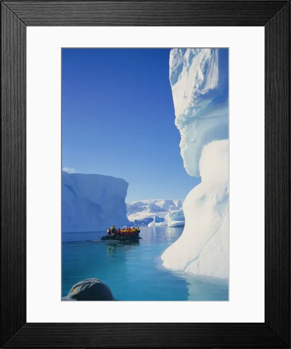 Framed Print : Tourists in inflatable cruising past icebergs, Antarctica Framed Print : Tourists in inflatable cruising past icebergs, Antarctica