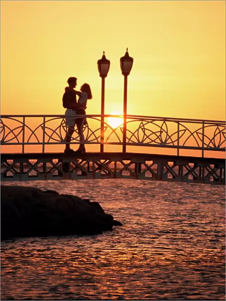 Couple on bridge at sunset, Aruba, West Indies, Dutch Caribbean, Central America