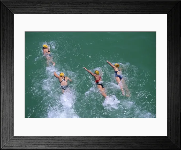 Framed Print : Competitors in the Henley and Grange swimming race that is swum between the piers of these two neighbouring seaside suburbs of Adelaide, South Australia Framed Print : Competitors in the Henley and Grange swimming race that is swum between the piers of these two neighbouring seaside suburbs of Adelaide, South Australia