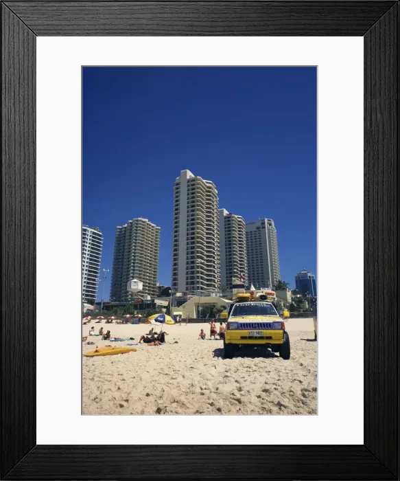 Framed Print : Lifeguards jeep on the beach at Surfers Paradise, with hotels and apartment blocks beyond Framed Print : Lifeguards jeep on the beach at Surfers Paradise, with hotels and apartment blocks beyond