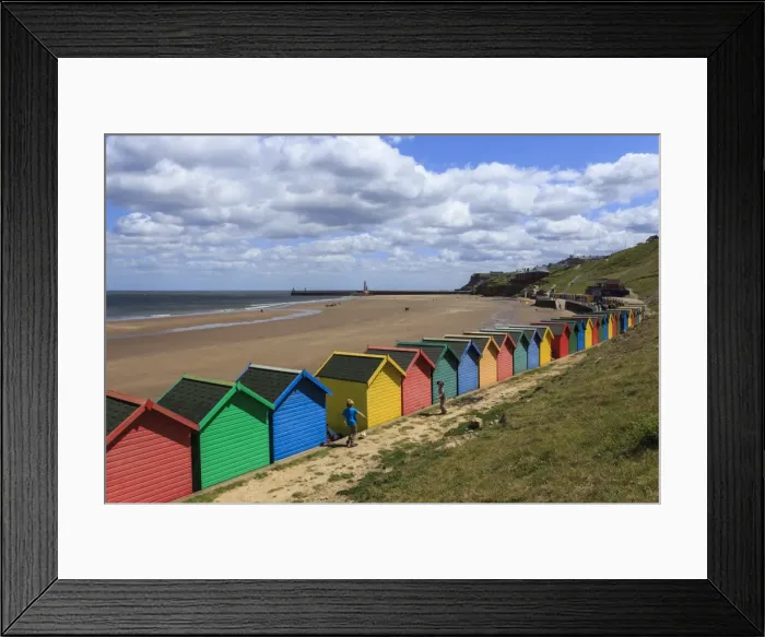 Framed Print : Children kick football near colourful beach huts above West Cliff Beach, Whitby, North Yorkshire Framed Print : Children kick football near colourful beach huts above West Cliff Beach, Whitby, North Yorkshire