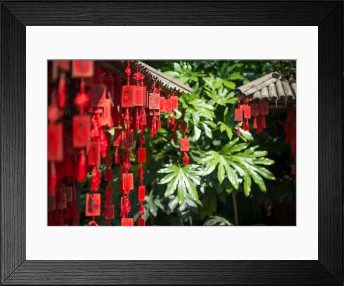 Framed Print : Red wooden Buddhist good luck charms and tropical vegetation, Hangzhou, Zhejiang Framed Print : Red wooden Buddhist good luck charms and tropical vegetation, Hangzhou, Zhejiang