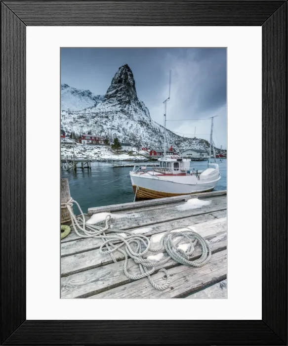 Framed Print : A boat moored in the cold sea in the background the snowy peaks, Reine. Lofoten Islands Framed Print : A boat moored in the cold sea in the background the snowy peaks, Reine. Lofoten Islands