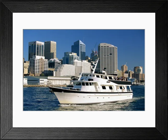 Framed Print : A tour boat in Darling Harbour, with the city skyline behind, in Sydney Framed Print : A tour boat in Darling Harbour, with the city skyline behind, in Sydney