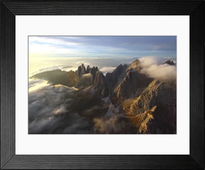 Framed Print : Aerial view of the mountain range of Odle surrounded by clouds in the Dolomites, Val Funes Framed Print : Aerial view of the mountain range of Odle surrounded by clouds in the Dolomites, Val Funes