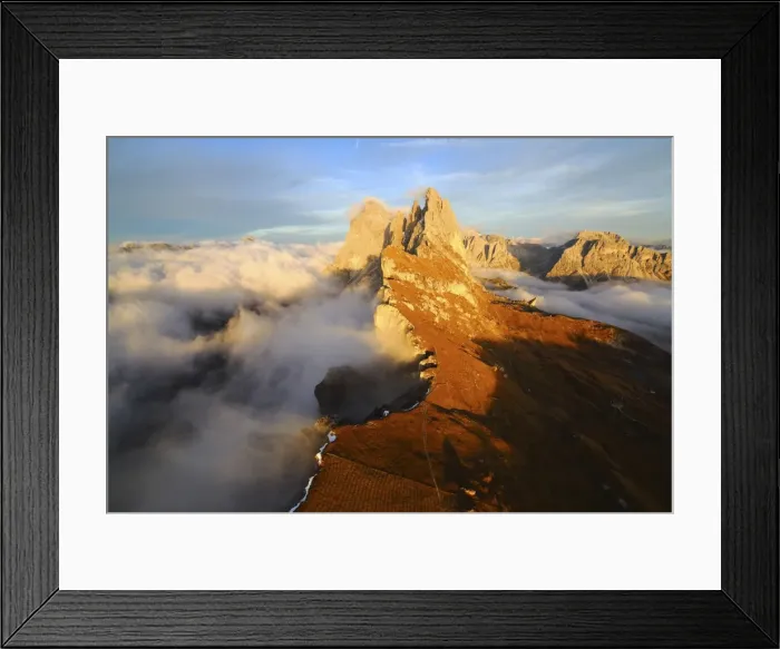 Framed Print : Aerial shot from Seceda of Odle surrounded by clouds at sunset in the Dolomites, Val Funes Framed Print : Aerial shot from Seceda of Odle surrounded by clouds at sunset in the Dolomites, Val Funes