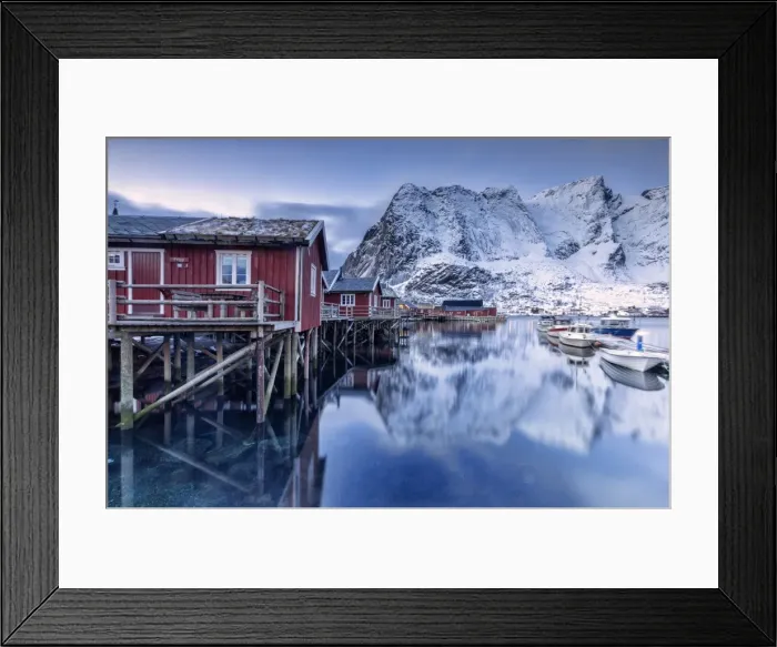 Framed Print : Snowy mountains and the typical red houses reflected in the cold sea at dusk, Reine Framed Print : Snowy mountains and the typical red houses reflected in the cold sea at dusk, Reine