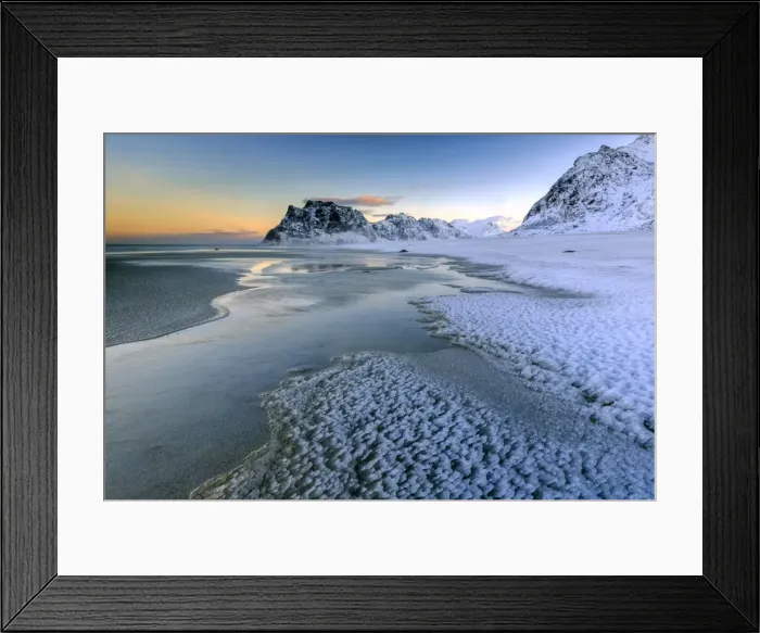Framed Print : Dawn illuminates the beach covered with frozen snow in the cold sea of Uttakleiv Framed Print : Dawn illuminates the beach covered with frozen snow in the cold sea of Uttakleiv