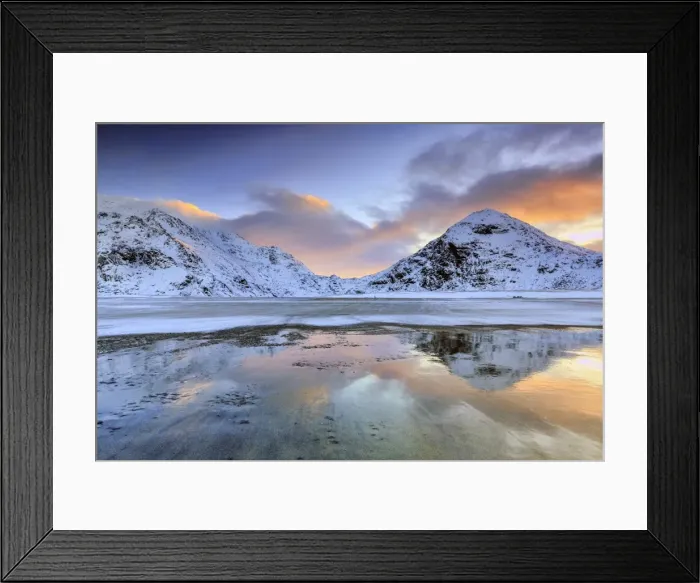 Framed Print : Sunrise on Uttakleiv beach surrounded by snow covered mountains reflected in the cold sea Framed Print : Sunrise on Uttakleiv beach surrounded by snow covered mountains reflected in the cold sea
