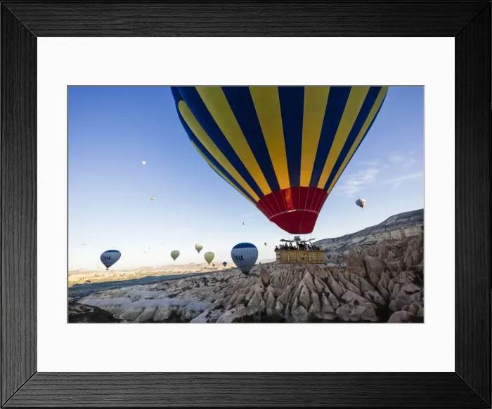 Framed Print : Hot air balloons flying among rock formations at sunrise in the Red Valley, Goreme National Park Framed Print : Hot air balloons flying among rock formations at sunrise in the Red Valley, Goreme National Park