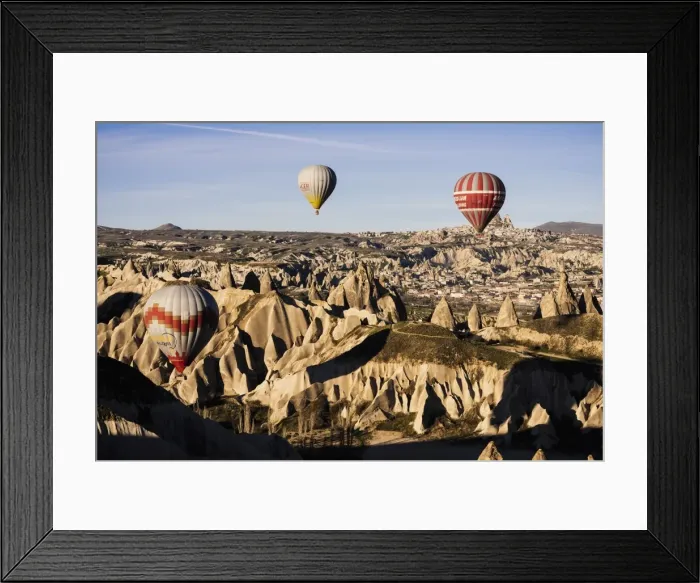 Framed Print : Hot air balloons flying among rock formations at sunrise in the Red Valley, Goreme National Park Framed Print : Hot air balloons flying among rock formations at sunrise in the Red Valley, Goreme National Park