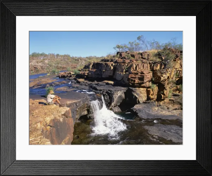 Framed Print : A man sitting on a rock up river, at the first stage of the Mitchell Falls in Kimberley Framed Print : A man sitting on a rock up river, at the first stage of the Mitchell Falls in Kimberley