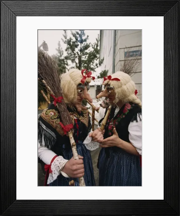 Framed Print : Two people wearing masks and traditional dress, one carrying a broomstick Framed Print : Two people wearing masks and traditional dress, one carrying a broomstick