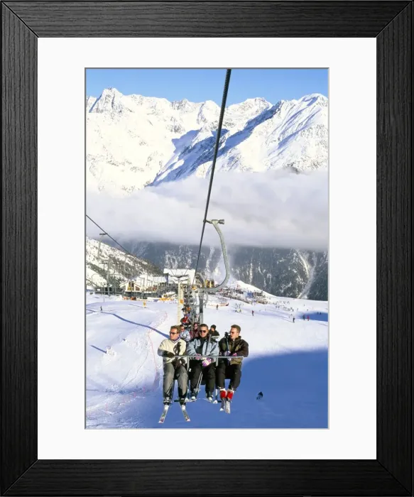 Framed Print : Skiers riding chairlift up to slopes from village of Solden, Tirol Alps Framed Print : Skiers riding chairlift up to slopes from village of Solden, Tirol Alps