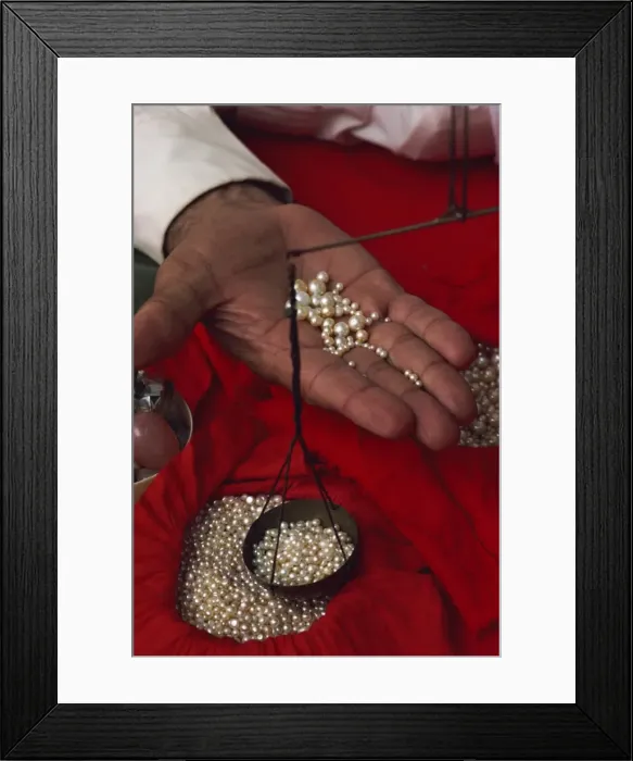 Framed Print : Close-up of hand displaying pearls with weighing scales, in the pearl souk Framed Print : Close-up of hand displaying pearls with weighing scales, in the pearl souk