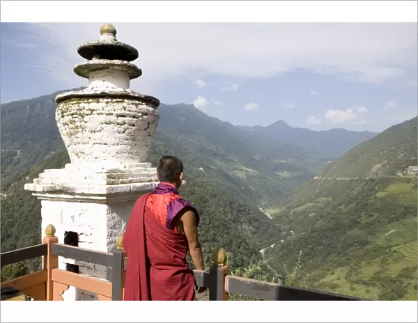 Buddhist monk looking over the Valley of the Puna Tsang River, Trongsa Dzong