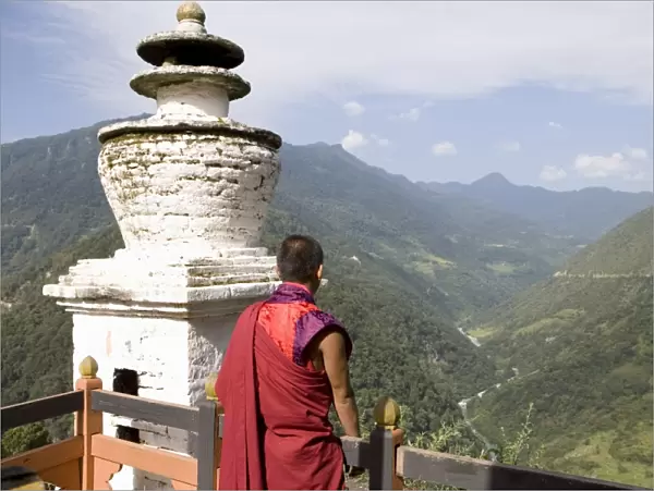 Buddhist monk looking over the Valley of the Puna Tsang River, Trongsa Dzong